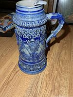 Full view of stein front showing relief knight scene and handle