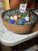Pottery bowl filled with assorted marbles