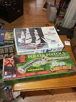 Both model kit boxes: USS Constitution and Pirate Pistols
