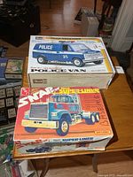 Both model kit boxes on table