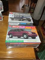 Front view of both sealed model kit boxes on table