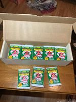 Open box showing rows of green Score Series 1 baseball card packs