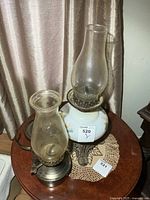 Both oil lamps side by side on table