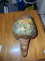 Overall view of burl top showing painted scene