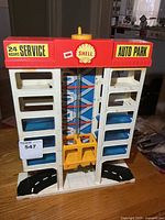 Front view of Shell Auto Park garage showing signage, elevator cage, parking decks, and base road pieces