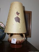 Full view of pottery lamp with conical shade