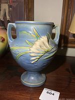 Front view of Roseville blue floral relief vase