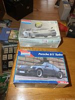 Two Monogram model kit boxes, Lamborghini sealed, Porsche open