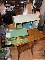 Two tin litho buildings on table, overall view