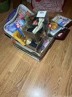 Stacked assortment of packaged Beanie Babies in vinyl case and blister cards
