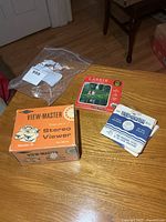 Viewer box, Lassie packet, blue packet on table