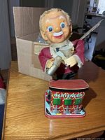 Full view of bartender toy on metal base