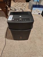 Front view showing entire dehumidifier, control panel, power cord