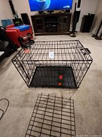 Overall view of assembled black wire crate with plastic tray and handles