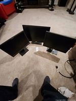 Three monitors arranged together showing fronts and stands