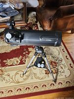 Telescope on tripod, showing optical tube, finder scope and accessory tray with eyepieces