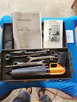 Open case showing manuals, wrenches, barrel and accessories