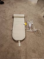 Mat unrolled showing stitched headrest and oval padded section