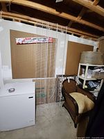 Three white wire shelving panels leaning against wall showing full length and width