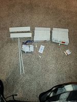 All components laid out: two blinds, two tilt wands, bag of brackets/hardware