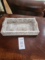 Top view of carved whitewashed wooden tray