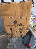 Front view showing nylon body, two buckle pockets, leather accents