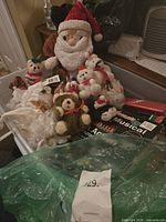 Tub with plush Santa, small plush ornaments, light set boxes visible