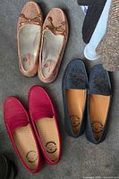 Top view of the three Marc Joseph pairs: rose-gold woven driver, navy suede embroidered loafer, red leather loafer