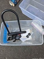 U-lock, mounting bracket parts, keys and manual inside plastic bin