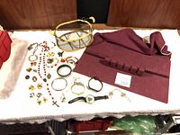 Overall view of jewelry, watches, jewelry roll, basket
