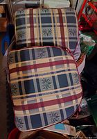 Two plaid seat cushions stacked