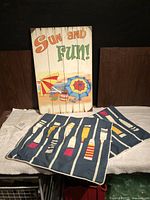 Overall lot showing wall sign and two pillow covers