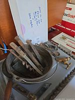 overall lot showing cast iron pot filled with hand tools and brass fittings