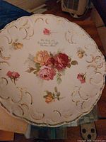 Round floral porcelain plate with gold gilding