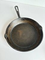 Top view showing cooking surface, handle, pour spouts