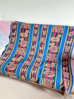 Full view of tapestry draped over sofa showing overall pattern and size