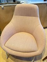 Front view of upholstered lounge chair showing seat and fabric