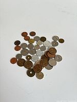 Group of approximately 38 assorted foreign coins in mixed metals and sizes