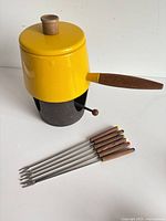 Complete fondue set assembled: pot on stand with six forks
