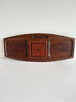 Front view of teak tray showing recessed sections and tile