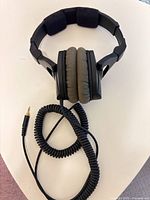 Full view of headphones with coiled cable and plug