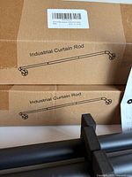 Two boxed curtain rods labeled Industrial Curtain Rod