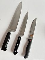 Three Zwilling Henckels knives side by side
