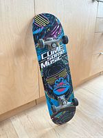 Underside of skateboard showing graphic, trucks and wheels