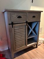 Front view showing drawers, sliding door, wine rack