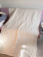 Full view of rug spread out on sofa showing overall size and pattern