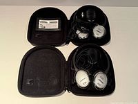Both open cases showing each Bose QuietComfort 3 headphone set, cables, chargers, booklet, airline adapter