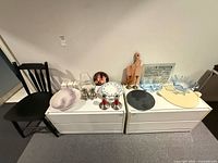overview of chair and assorted kitchenware on two dressers