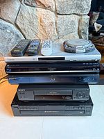 Stack of all components with remotes and portable CD player visible