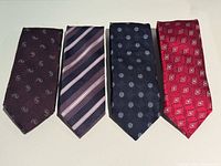 Four silk ties laid flat showing full patterns.